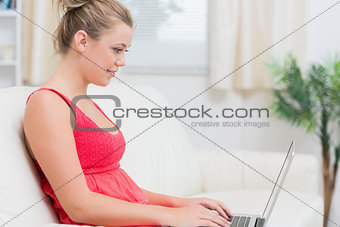 Woman using laptop and smiling