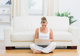 Blonde sitting on the floor with laptop