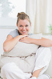 Woman holding pillow and smiling