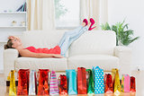 Woman lying on the sofa tired after shopping
