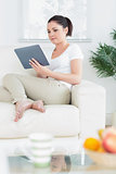 Woman on the couch using a tablet computer