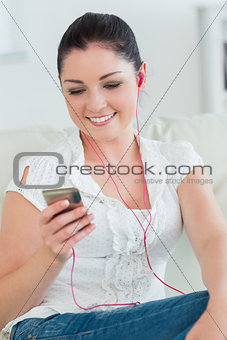 Woman listening to music while sitting on the couch