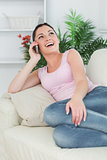 Phoning woman lying on the couch