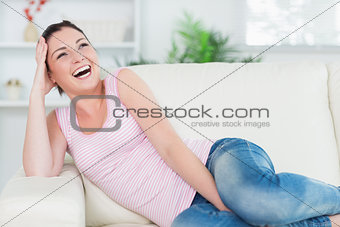 Laughing woman relaxing on the couch