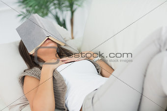 Woman sleeping with her book on the head
