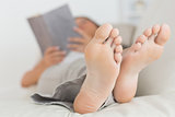 Woman with her feet up reading a book