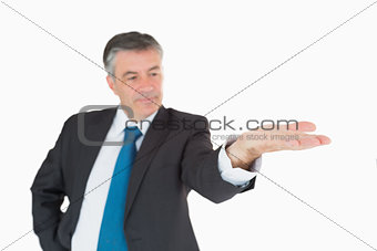 Serious businessman holding out hand