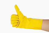 Female hand in yellow glove giving the thumbs up
