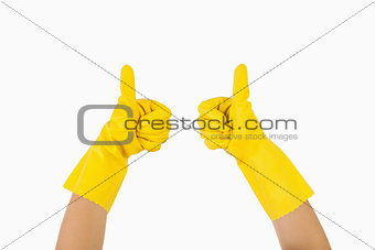 Female hands in gloves showing thumbs up