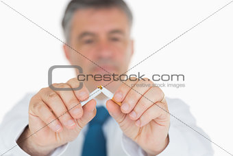 Man breaking cigarette