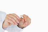 Male hands breaking a cigarette