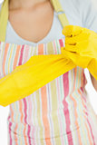 Woman pulling off rubber gloves