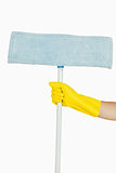 Female hand in glove holding mop