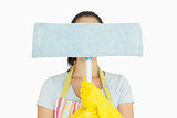 Woman hiding behind dust mop