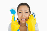 Distressed woman holding cloth and scrubbing brush