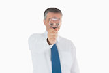 Businessman behind magnifying glass