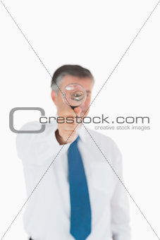 Businessman using a magnifying glass