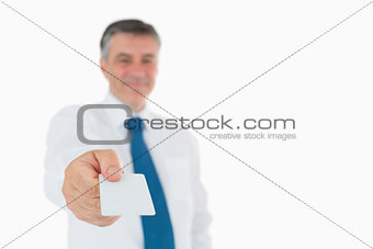 Businessman holding out his card