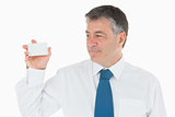 Man holding up and looking at his business card
