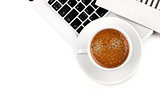 Cappuccino cup on laptop. Above view