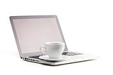 Cappuccino cup on laptop