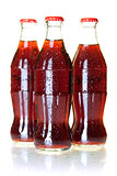 Three bottles of cold cola