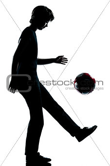 one young teenager boy or girl silhouette juggling soccer footba