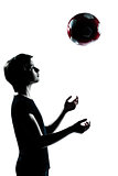one young teenager boy  girl silhouette tossing soccer football