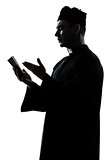 man priest silhouette reading bible