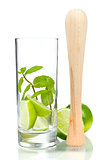Mojito mix: lime, mint in glass and muddler 