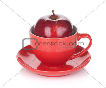 Ripe red apple in tea cup