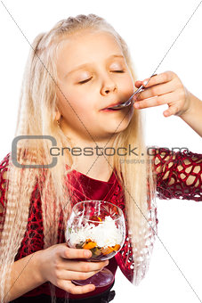 Beautiful blonde girl eating dessert