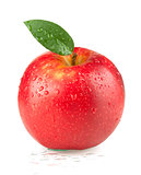 A ripe red apple with green leaf