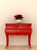 Red chest of drawers and a plant