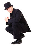 Man in black austere suit and hat