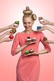 smiling girl with many colorful cupcakes  