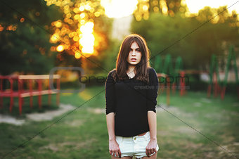 fashionable stylish girl in black shirt outdoor during sunset