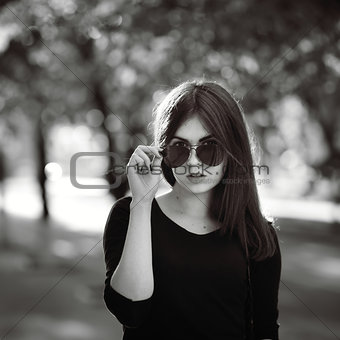 fashionable stylish girl in black shirt wearing sunglasses, blac