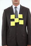 Businessman covered in yellow memo pads