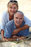 Couple sitting on a sand dune