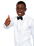 African boy in party-wear gesturing thumbs-up