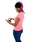 Girl listening to music via portable tablet