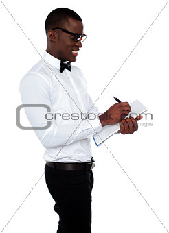 African employee writing on clipboard