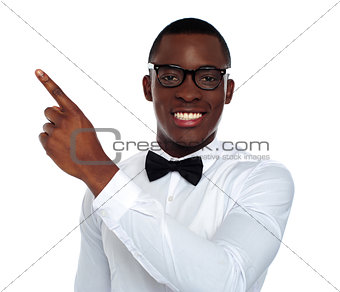Welldressed young person pointing away