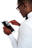 Rear-view of african holding a touch-pad device