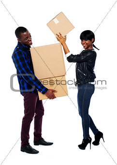 Smiling couple moving cardboard boxes