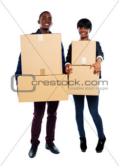 Attractive african couple holding cardboard boxes