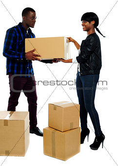 Couple moving empty cartons