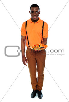 Full length portrait of delivery boy with pizza
