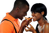 Young couple sharing a slice of pizza